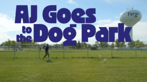 Text that reads "AJ Goes to the Dog Park" above a dog park where AJ chases after his two dogs who have blown away in the wind.